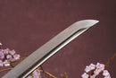 A close-up view of Moonswords Ghost of Tsushima Tanto with Clay-tempered Damascus steel blade