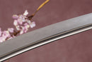 A close-up view of Moonswords Ghost of Tsushima Tanto with Clay-tempered Damascus steel blade