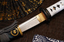 A close-up view of Moonswords Ghost of Tsushima Tanto with Clay-tempered Damascus steel blade