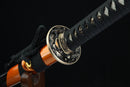 Bronze tsuba guard of Fūrai katana featuring traditional Japanese metalwork complementing Damascus steel blade