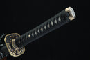 Sword with black scabbard and gold decorative elements on a dark background