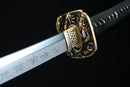 Aged bronze tsuba guard of Tenma katana featuring traditional Japanese metalwork with authentic patina finish