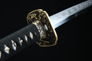 Aged bronze tsuba guard of Tenma katana featuring traditional Japanese metalwork with authentic patina finish