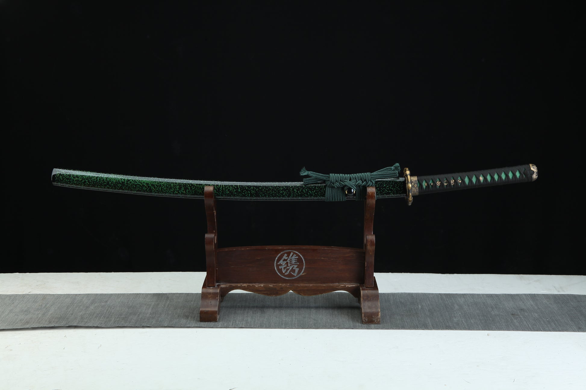 Sword on a wooden stand with a black background
