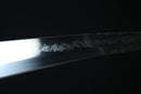 Close-up of a sword blade with a dark background