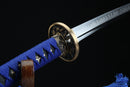 Sword with blue handle and gold guard on a black background