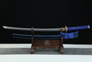 Sword with blue scabbard on a wooden stand against a black background