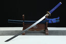 Sword with blue scabbard on a wooden stand against a black background
