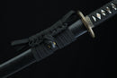 Black sword with decorative hilt on a black background