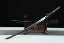 Sword on a wooden stand with a black background