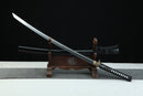 Sword on a wooden stand with a black background