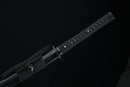 Black sword with textured handle on a black background