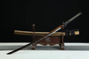 Sword on a wooden stand with a black background