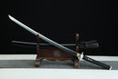 Sword on a wooden stand with a black background