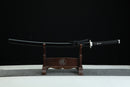 Sword on a wooden stand against a black background