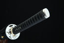 Close-up of a black sword handle with white guard on a black background
