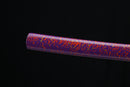 Purple and orange striped cylindrical object on a black background