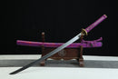 Sword with a purple sheath on a wooden stand against a black background