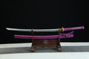 Sword with purple sheath on a stand against a black background