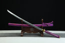Sword with purple sheath on a wooden stand against a black background