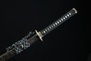 Decorative sword with a black sheath on a black background