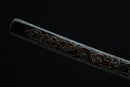 Decorative Katana with intricate patterns on a black background