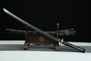 Sword on a wooden stand with a dark background