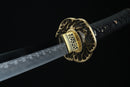 Sword with a decorative gold hilt on a black background