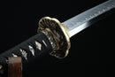 Close-up of a sword with decorative hilt on a black background