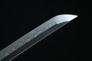 Close-up of a sword blade with a dark background