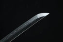 Close-up of a sword blade with a dark background