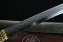 Close-up of a sword blade with engraved patterns on a dark background