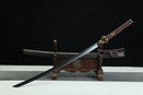 Sword with sheath on a stand against a black background