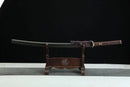 Sword on a wooden stand against a black background