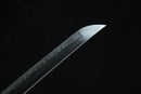 Close-up of a sword blade with a dark background