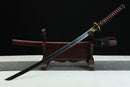 Sword on a wooden stand with a black background