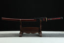 Sword on a wooden stand against a black background