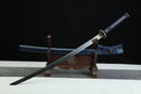 Sword with blue sheath on a wooden stand against a black background