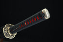 Sword with black sheath featuring red patterns on a black background