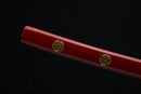 Katana with gold floral designs on a black background