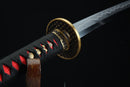 Sword with a black sheath featuring red patterns on a dark background