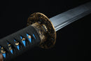 Sword with gold handle and black sheath on a dark background