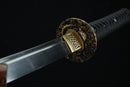 Close-up of a sword with a decorative handle on a black background