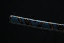 A close-up view of a blue and gold-colored Katana Shealth gainst a dark background.