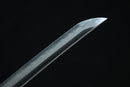 Sword blade with hamon on a black background
