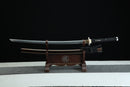 Sword on a wooden stand against a black background