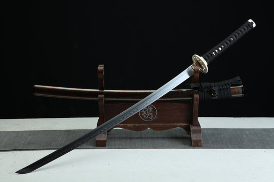 Sword with sheath on a wooden stand against a black background