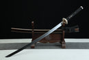Sword with sheath on a wooden stand against a black background