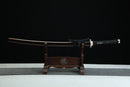 Sword on a wooden stand with a dark background