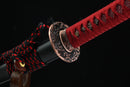 A photo of Moonswords Kafuun Katana with a red bronze guard, is shown against a black background.